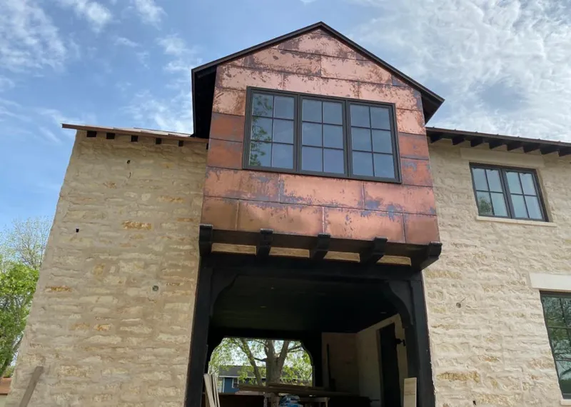Copper metal panel facade on a stone building for Skylight Installation in Grand Island